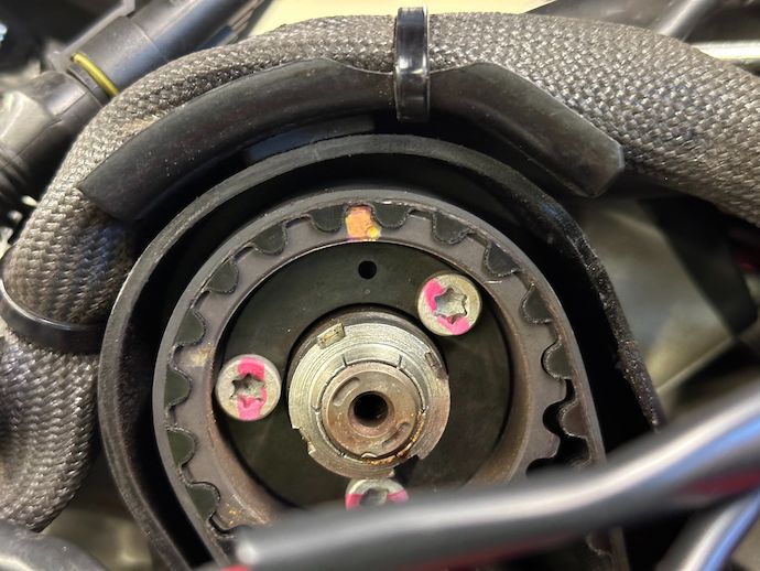Rear cylinder timing pulley with paint pen marks on flange screws running tangent to rotation