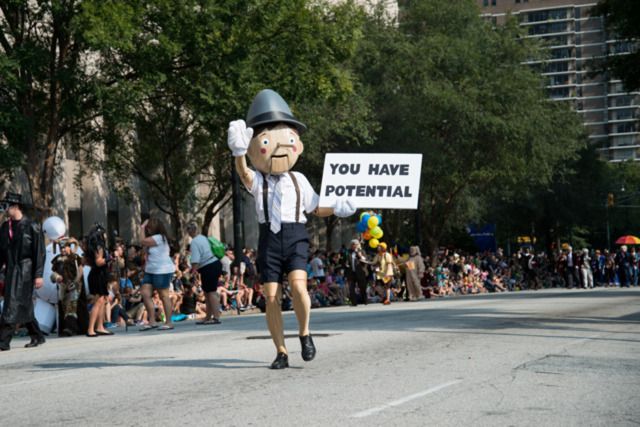 Pinocchio as a motivational speaker, holding a sign reading "YOU HAVE POTENTIAL"