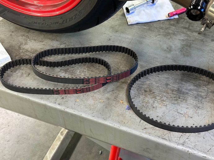 Ducati belts lying next to a removed Dayco belt